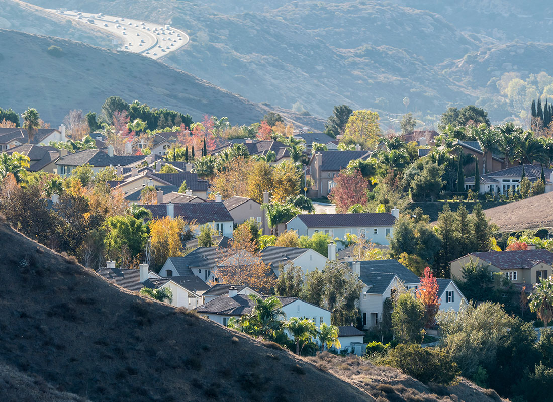 Contact - Aerial View of Suburban Southern California Hillside Homes With Simi Valley Route 118 Freeway in the Background